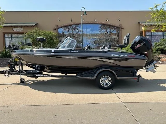 Slide: The Image of 2025 Ranger 1880MS boat on trailer, parked outdoors, side view. - 0
