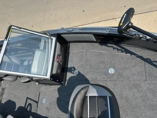 Slide: The Image of 2025 Ranger 1880MS boat interior with open windshield and trolling motor. - 7