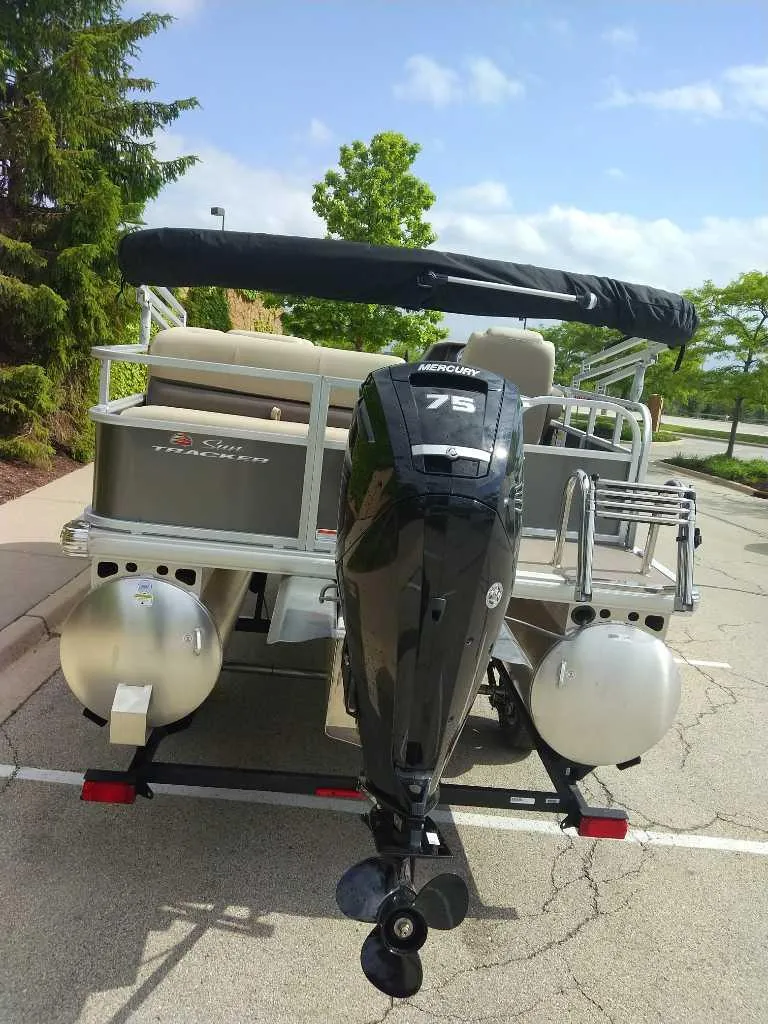 Slide: The Image of 2025 Sun Tracker Party Barge 18 DLX pontoon boat with Mercury 75 outboard motor. - 5