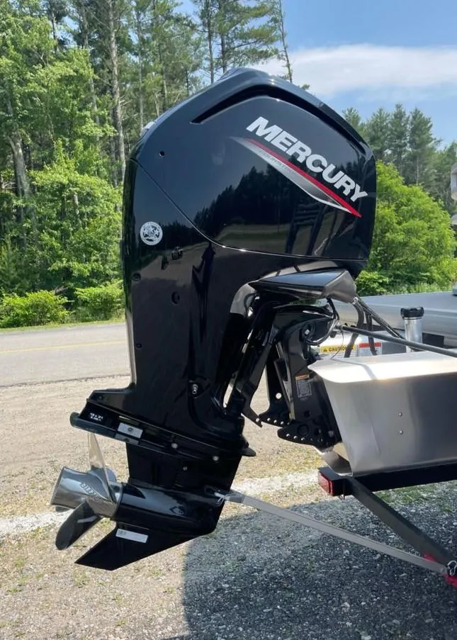 Slide: The Image of 2025 Sun Tracker Party Barge 20 DLX with Mercury outboard motor, parked outdoors. - 5