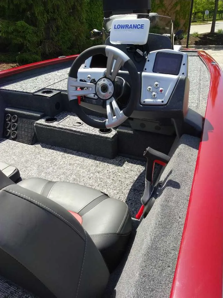 Slide: The Image of 2025 Tracker Pro Team 195 Tournament Edition boat interior with steering wheel and Lowrance electronics. - 2