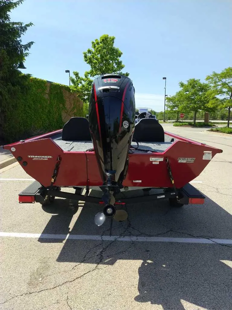 Slide: The Image of 2025 Tracker Pro Team 195 Tournament Edition boat, rear view, parked outdoors. - 3