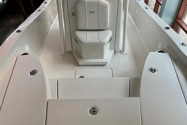 Slide: The Image of 2025 Ranger 2510 Bay boat interior with white seating and storage compartments. - 10