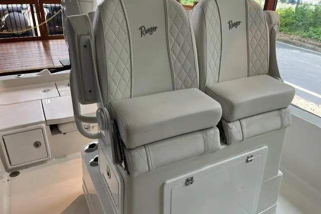 Slide: The Image of 2025 Ranger 2510 Bay boat seats with quilted design and storage compartment. - 6