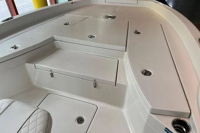 Slide: The Image of 2025 Ranger 2510 Bay boat interior with storage compartments and seating. - 5