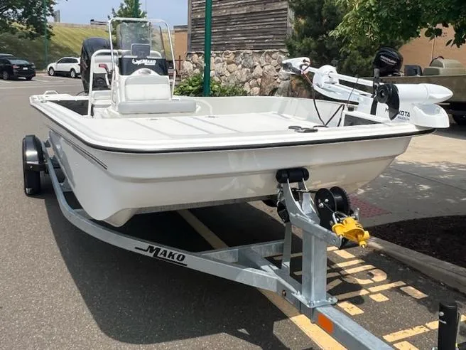 Slide: The Image of 2025 Mako Pro Skiff 17 CC boat on trailer in parking lot. - 2