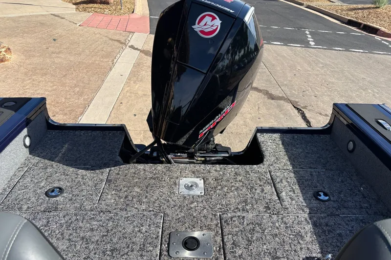 Slide: The Image of 2025 Tracker Targa V-18 WT boat with Mercury outboard motor on a paved surface. - 13
