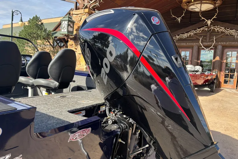 Slide: The Image of 2025 Tracker Targa V-18 WT boat with powerful outboard motor, parked outdoors. - 14