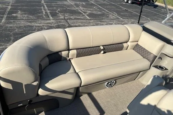 Slide: The Image of 2025 Sun Tracker SportFish 20 DLX boat interior with beige seating and cup holder. - 4