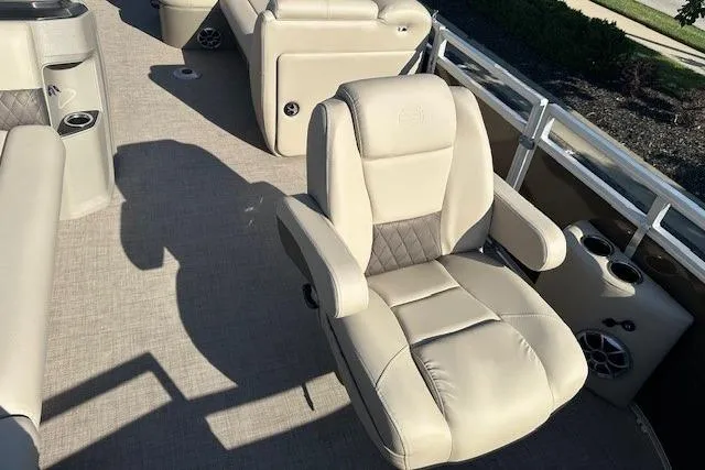 Slide: The Image of 2025 Sun Tracker SportFish 20 DLX boat interior with plush seating and cup holders. - 5