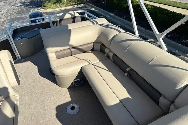 Slide: The Image of 2025 Sun Tracker SportFish 20 DLX pontoon boat with beige seating and spacious deck. - 6