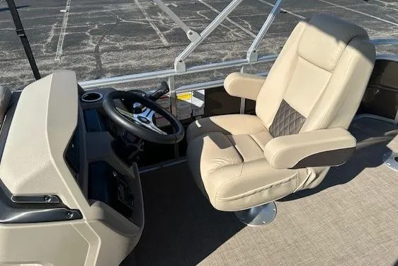 Slide: The Image of 2025 Sun Tracker SportFish 20 DLX boat interior with beige captain's chair and steering console. - 7