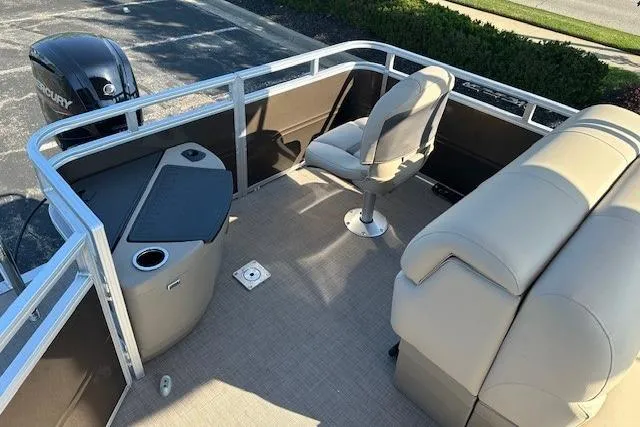 Slide: The Image of 2025 Sun Tracker SportFish 20 DLX pontoon boat interior with seating and storage. - 9