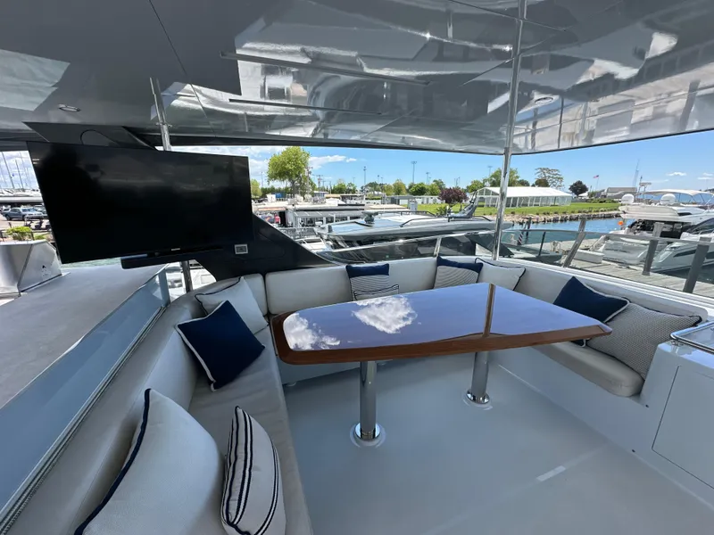 Slide: The Image of Luxurious 2023 CL Yachts CLB65 yacht deck with seating, table, and TV. - 15