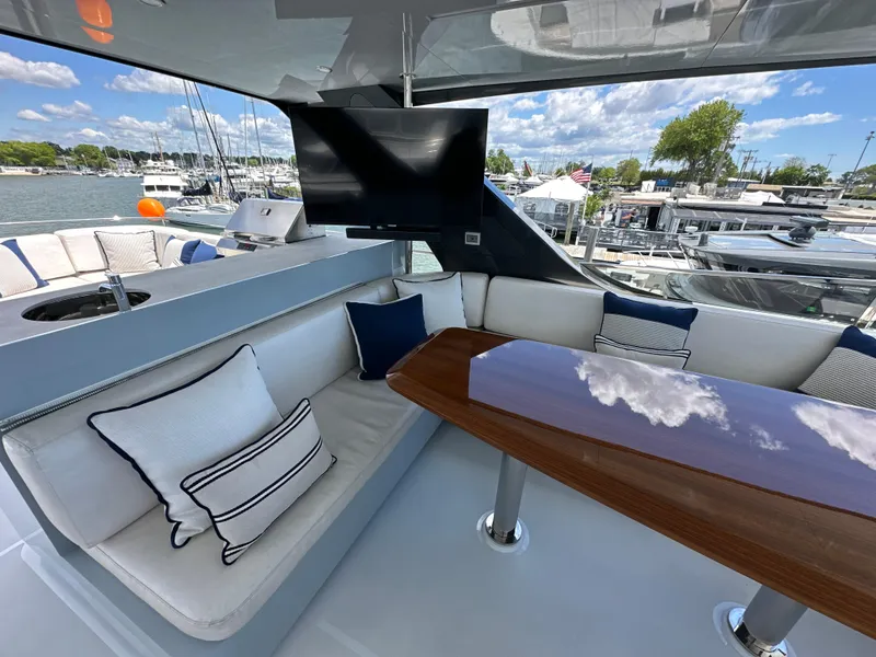 Slide: The Image of Luxurious seating area on 2023 CL Yachts CLB65 with TV and marina view. - 16