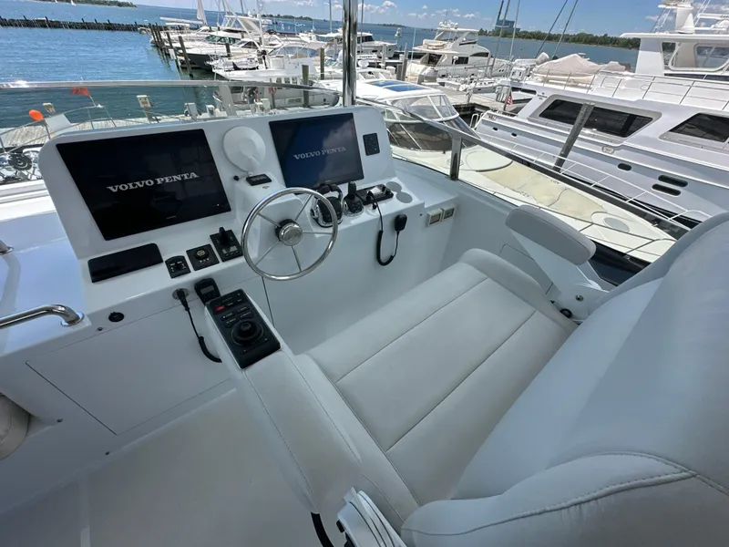Slide: The Image of Helm of 2023 CL Yachts CLB65 with Volvo Penta controls, docked at marina. - 17