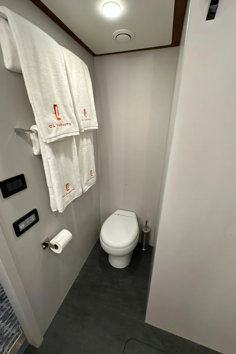 Slide: The Image of 2023 CL Yachts CLB65 bathroom with modern fixtures and branded towels. - 44