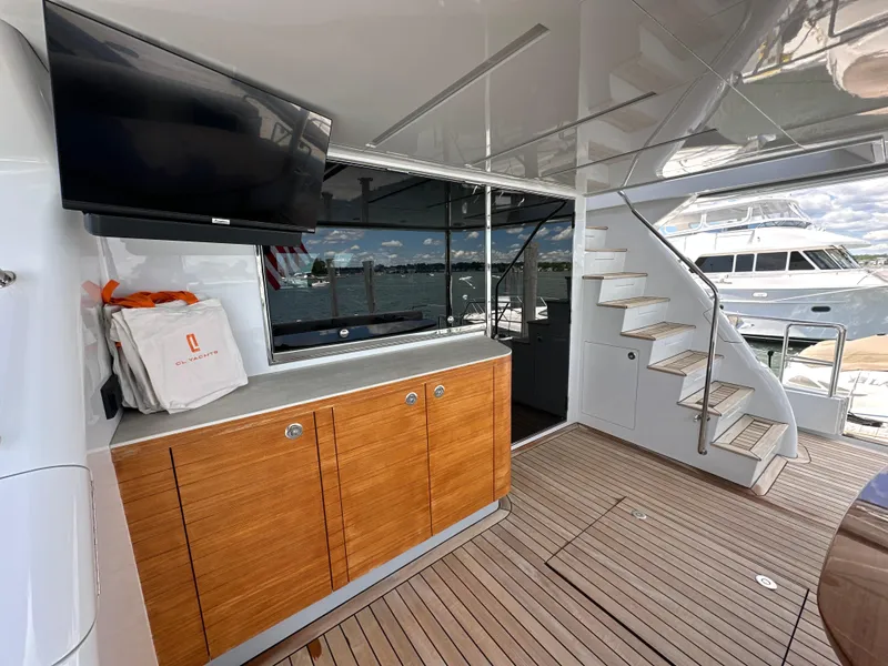 Slide: The Image of Luxurious 2023 CL Yachts CLB65 interior with wooden cabinetry and modern staircase. - 6
