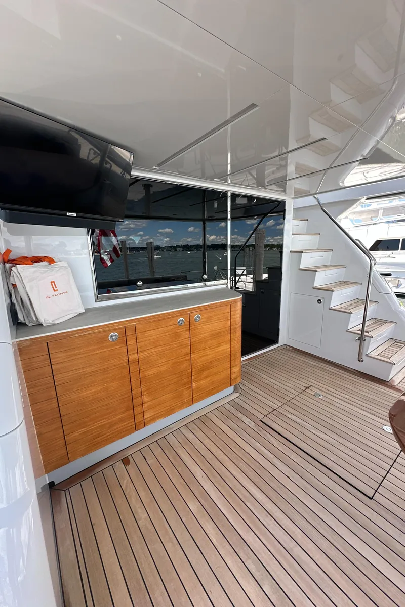 Slide: The Image of 2023 CL Yachts CLB65 yacht interior with wooden cabinetry and stairs, showcasing luxury design. - 8