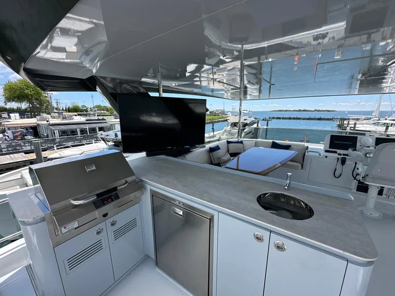 Slide: The Image of Luxurious 2023 CL Yachts CLB65 yacht deck with modern amenities and scenic marina view. - 14