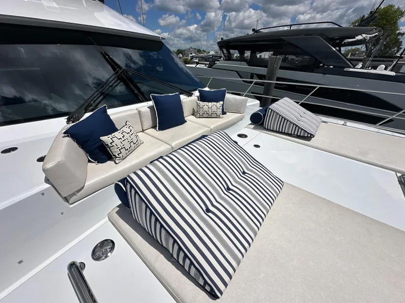 Slide: The Image of 2023 CL Yachts CLB65 luxury yacht with stylish outdoor seating and striped cushions. - 21