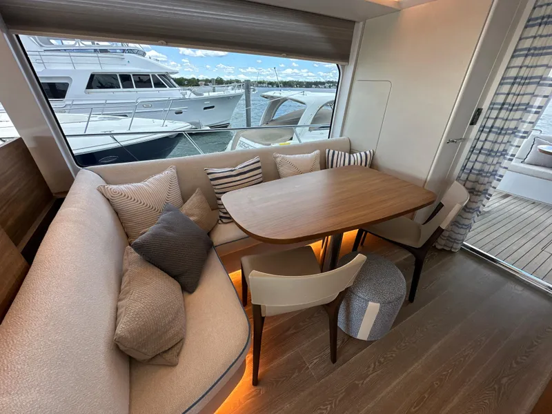 Slide: The Image of 2023 CL Yachts CLB65 interior with elegant dining area and scenic window view. - 30