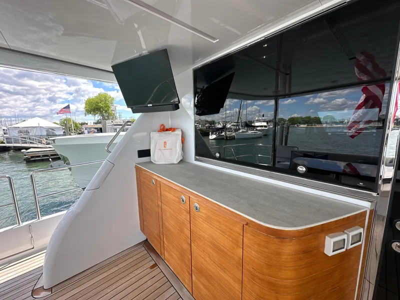 Slide: The Image of 2023 CL Yachts CLB65 yacht deck with wooden cabinetry and waterfront view. - 5