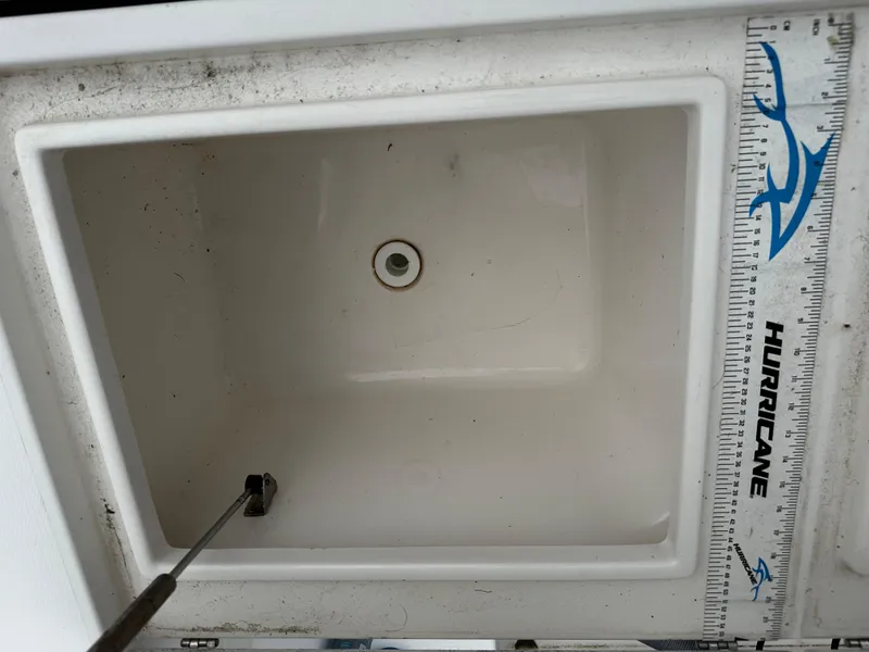 Slide: The Image of 2005 Regulator 32 FS boat compartment with measuring ruler and drain plug. - 10