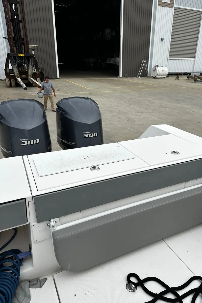 Slide: The Image of 2005 Regulator 32 FS boat with twin 300 engines at a dockyard. - 13