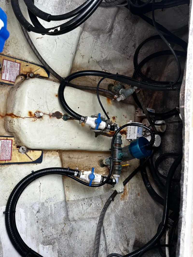 Slide: The Image of 2005 Regulator 32 FS boat engine compartment with hoses and fittings. - 14