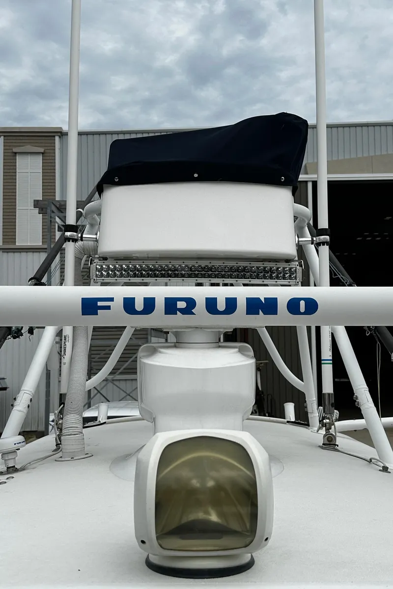Slide: The Image of 2005 Regulator 32 FS boat with Furuno radar, docked under cloudy skies. - 6