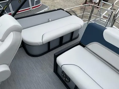 Slide: The Image of 2025 Godfrey SWEETWATER 2286SFL boat interior with white and blue seating. - 11