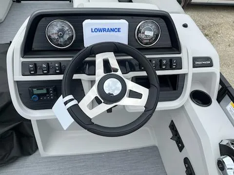 Slide: The Image of 2025 Godfrey SWEETWATER 2286SFL boat dashboard with steering wheel and Lowrance display. - 16