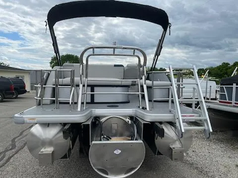 Slide: The Image of 2025 Godfrey SWEETWATER 2286SFL pontoon boat with canopy, rear view, parked outdoors. - 6