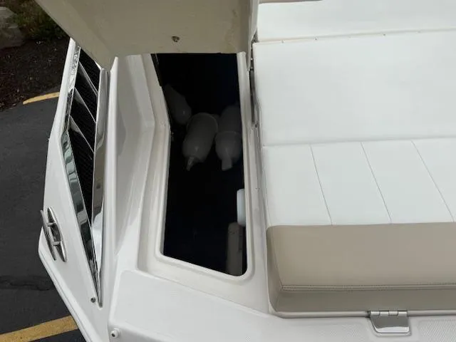 Slide: The Image of 2012 Regal 24 FasDeck boat storage compartment with fenders inside. - 10