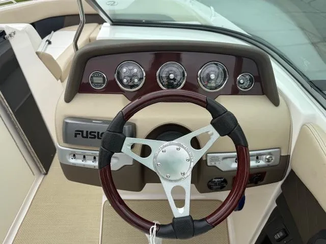 Slide: The Image of 2012 Regal 24 FasDeck boat dashboard with steering wheel and instrument panel. - 13