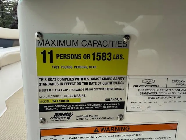Slide: The Image of 2012 Regal 24 FasDeck capacity label: 11 persons or 1583 lbs, safety compliance details. - 14