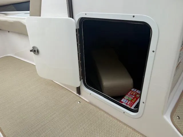 Slide: The Image of Open storage compartment on 2012 Regal 24 FasDeck boat interior. - 19