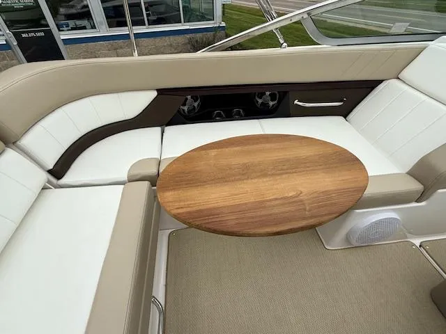 Slide: The Image of Interior of 2012 Regal 24 FasDeck boat with seating and wooden table. - 22