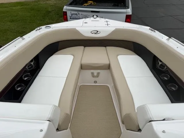 Slide: The Image of 2012 Regal 24 FasDeck boat interior with beige and white seating. - 23