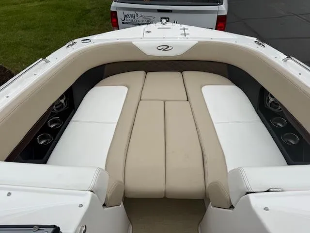 Slide: The Image of 2012 Regal 24 FasDeck boat interior with beige and white seating. - 24