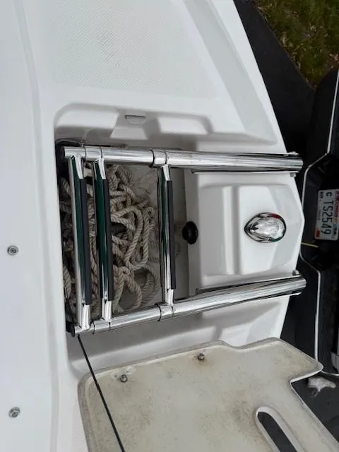 Slide: The Image of 2012 Regal 24 FasDeck boat ladder and storage compartment with ropes. - 25