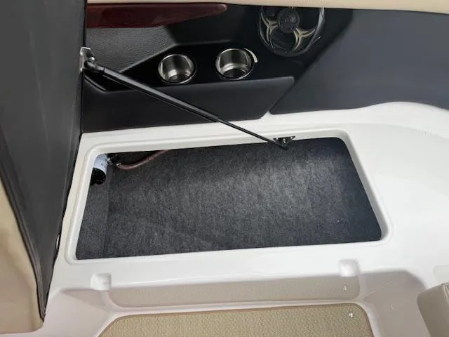 Slide: The Image of Storage compartment in 2012 Regal 24 FasDeck boat interior with cup holders and speaker. - 27