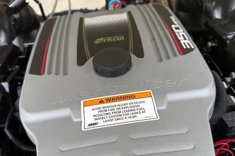 Slide: The Image of Engine cover of a 2012 Regal 24 FasDeck with warning label. - 30