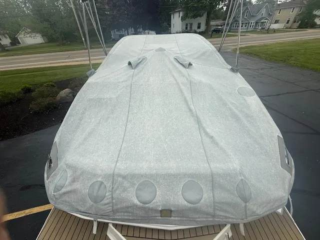 Slide: The Image of Covered 2012 Regal 24 FasDeck boat parked on driveway. - 34