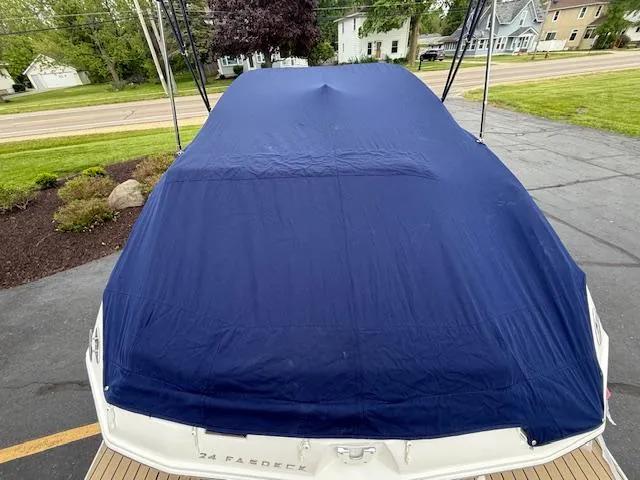 Slide: The Image of Covered 2012 Regal 24 FasDeck boat parked on driveway. - 35