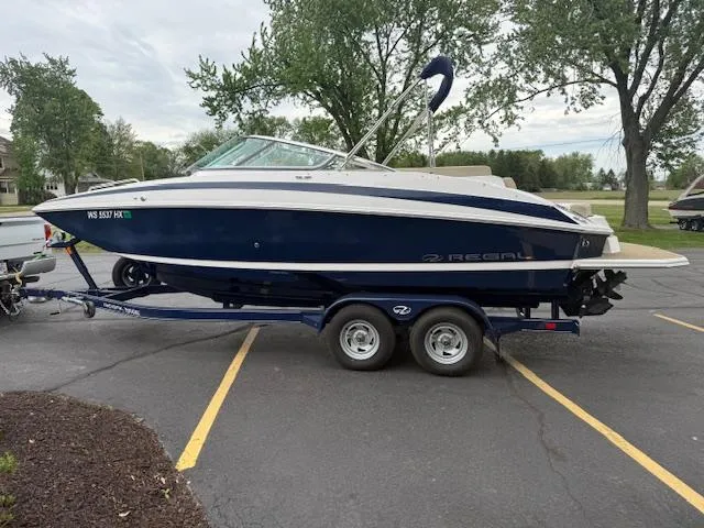 Slide: The Image of 2012 Regal 24 FasDeck boat on trailer in parking lot. - 4