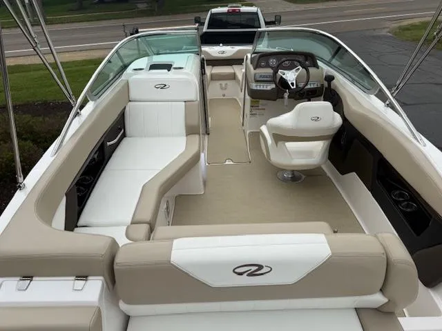 Slide: The Image of 2012 Regal 24 FasDeck boat interior with beige and white seating, steering wheel, and dashboard. - 8