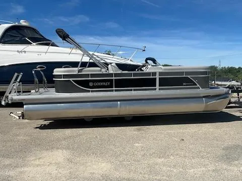 The Image of 2025 Godfrey EX2286SBCX pontoon boat parked on a sunny day. - 0