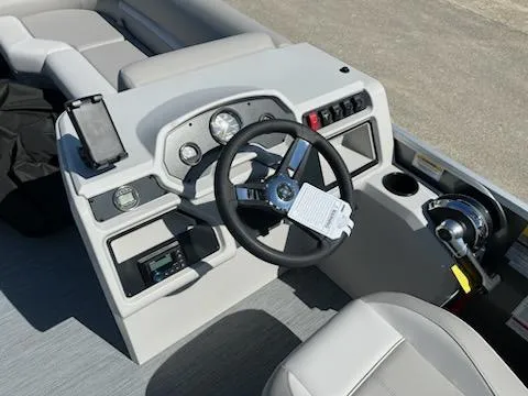 Slide: The Image of 2025 Godfrey EX2286SBCX boat dashboard with steering wheel and controls. - 14